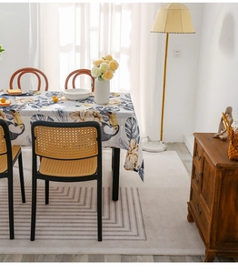 Detailed view of the oil-proof tablecloth with tropical toucan and leaf patterns