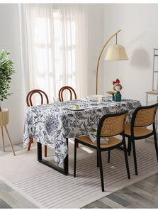 Detail of blue bird and flower patterns on a rectangular linen blend tablecloth