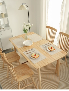 Detail of solid wood dining set with clear natural grain and rounded table corners