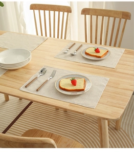 Close-up of light beige linen napkins on a wooden table with natural texture