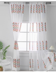 Detailed close-up of colorful embroidered leaf patterns on white semi-sheer curtains