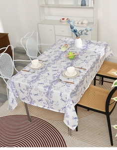 Detail of dragonfly and floral print on rectangular tablecloth in dining room setting
