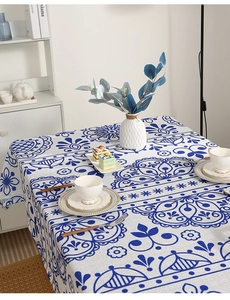 Detailed close-up of blue and white mandala pattern tablecloth with cotton linen texture