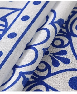 Macro view of blue baroque pattern on white rectangle tablecloth with woven texture