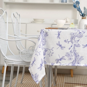 Linen rectangular tablecloth with blue dragonfly and floral patterns in a modern home setting
