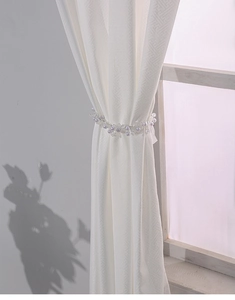 Detail of beaded curtain tieback with white pearls on waterproof gazebo outdoor curtains