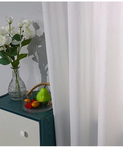 Detail showing white outdoor waterproof curtain with elegant geometric jacquard texture