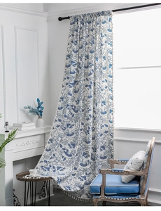 Detail of blue elephant floral printed curtain with decorative tassel trim