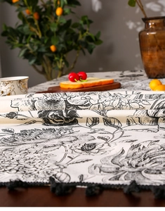 Detailed view of Nordic black floral print linen tablecloth with decorative fringe tassels