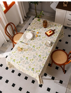 Linen rectangle tablecloth with green leaves, blue flowers, and white fringe tassels