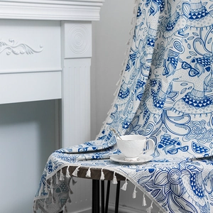 Fresh alpaca print fabric with white cotton tassels for home decor on a wooden table