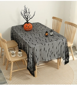 Detailed view of Halloween black lace tablecloth featuring bat patterns and forest edge
