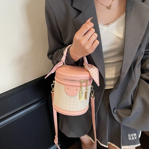 Pink and white woven bucket bag with leather handle and silk scarf decoration