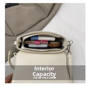 Détails de la capacité interne du sac à bandoulière crème avec compartiments de rangement