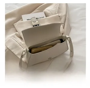 Spacious interior of beige leather saddle bag showing storage for phone and wallet