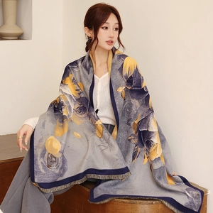 Detail of grey cashmere-feel shawl with yellow rose print and soft fringed edges