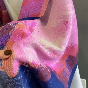 Close-up of soft cashmere-like scarf fabric with vibrant abstract oil painting patterns