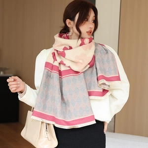 Detail view of thickened cashmere-like scarf featuring pink floral and argyle patterns