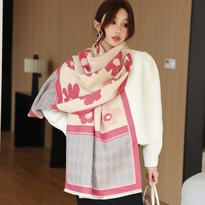 Detail of floral and diamond pattern on soft cashmere-like scarf with fringe edges
