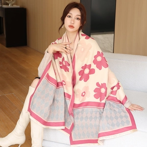 Detail of soft cashmere-like shawl featuring floral and diamond patterns with fringe