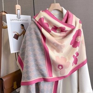 Detail of cashmere-like scarf showing diamond lattice pattern and floral prints on hanger