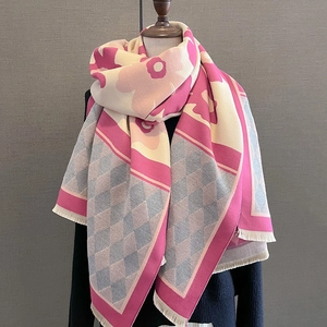 Detail of pink and grey faux cashmere scarf with floral pattern and fringe edges