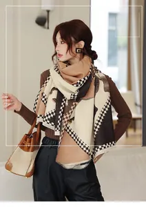 Detail view of thickened cashmere-like shawl scarf with plaid patterns and soft texture