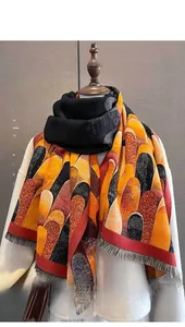 Close-up of winter scarf showing wave pattern geometric color-block and fringe trim