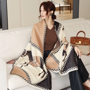 Detail of horse pattern and checkerboard border on thick cashmere-feel scarf with tassels