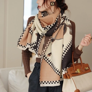 Close-up of thick beige and brown checkered scarf with fringe details and soft texture