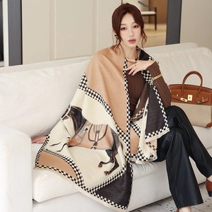 Detail of soft cashmere-like shawl featuring vintage horse patterns and checkered borders