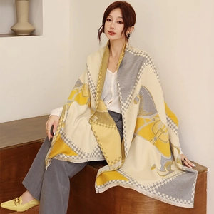 Close-up of thick yellow and beige cashmere-feel shawl with horse and checkerboard patterns