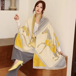 Detail of horse print and checkerboard pattern on yellow cashmere-like scarf with tassels