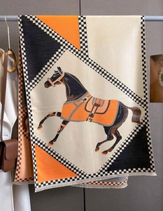 Close-up of horse motif and geometric patterns on a thick double-sided cashmere-like scarf