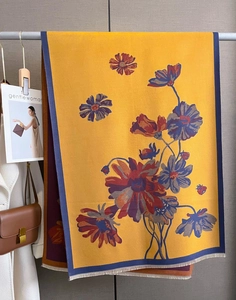 Detail of floral ginger cashmere-like scarf with fringe edges and premium urban styling
