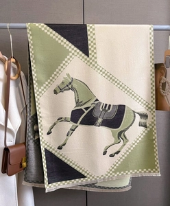 Detail of horse pattern scarf with fringe edges and soft cashmere-like texture fabric