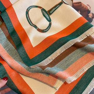 Detail of elegant chain pattern scarf with silky texture and fine fringe edges