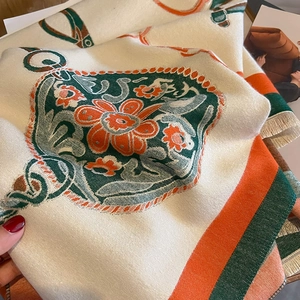 Close-up of thick floral cashmere shawl showing soft texture and tassel edge detail