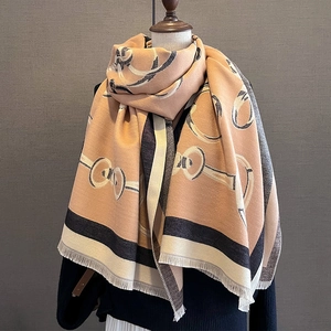 Close-up of thick winter scarf showing horse-bit pattern and soft fringe edges