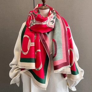 Detail of red oversized thick scarf with vintage chain print and fringe edges