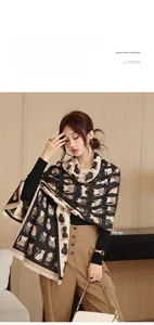 Detailed close-up of the cat print pattern and soft tassel edges on the winter scarf
