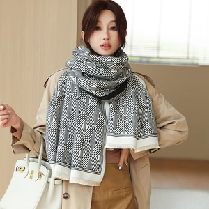 Close-up of black and white geometric pattern scarf with detailed tassel edge