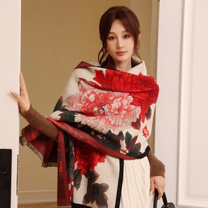 Close-up of vintage cashmere-like shawl featuring red peony patterns and fringe edges