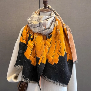 Thick winter scarf with geometric color block patterns in beige and orange fringe
