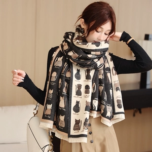 Close-up of thick scarf with cat print patterns and fine fringe tassels on the edges