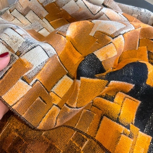 Winter checkered cashmere scarf with orange and black geometric pattern and thick fabric