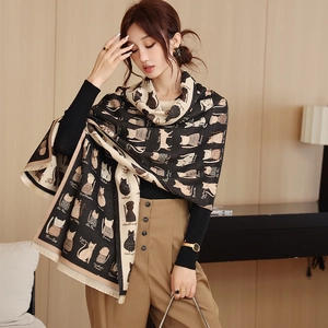Detail of soft thick scarf with cartoon cat patterns and short fringe edges