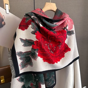 Thick vintage floral pashmina shawl with red peonies and black fringe on a hanger