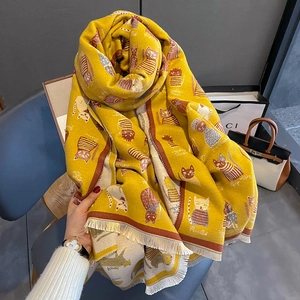 Yellow cashmere feel scarf featuring cartoon cat patterns and fringe details