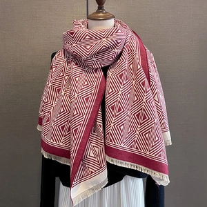 Winter plaid scarf with red and beige geometric pattern and decorative fringe detail
